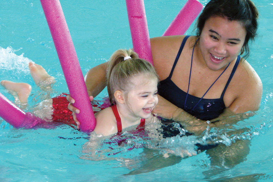 Swimming lessons, girl giggling